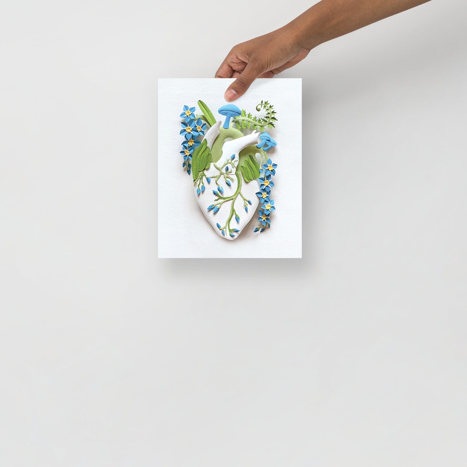 anatomical heart with mushrooms and blue forget-me-not flowers made of hand cut paper