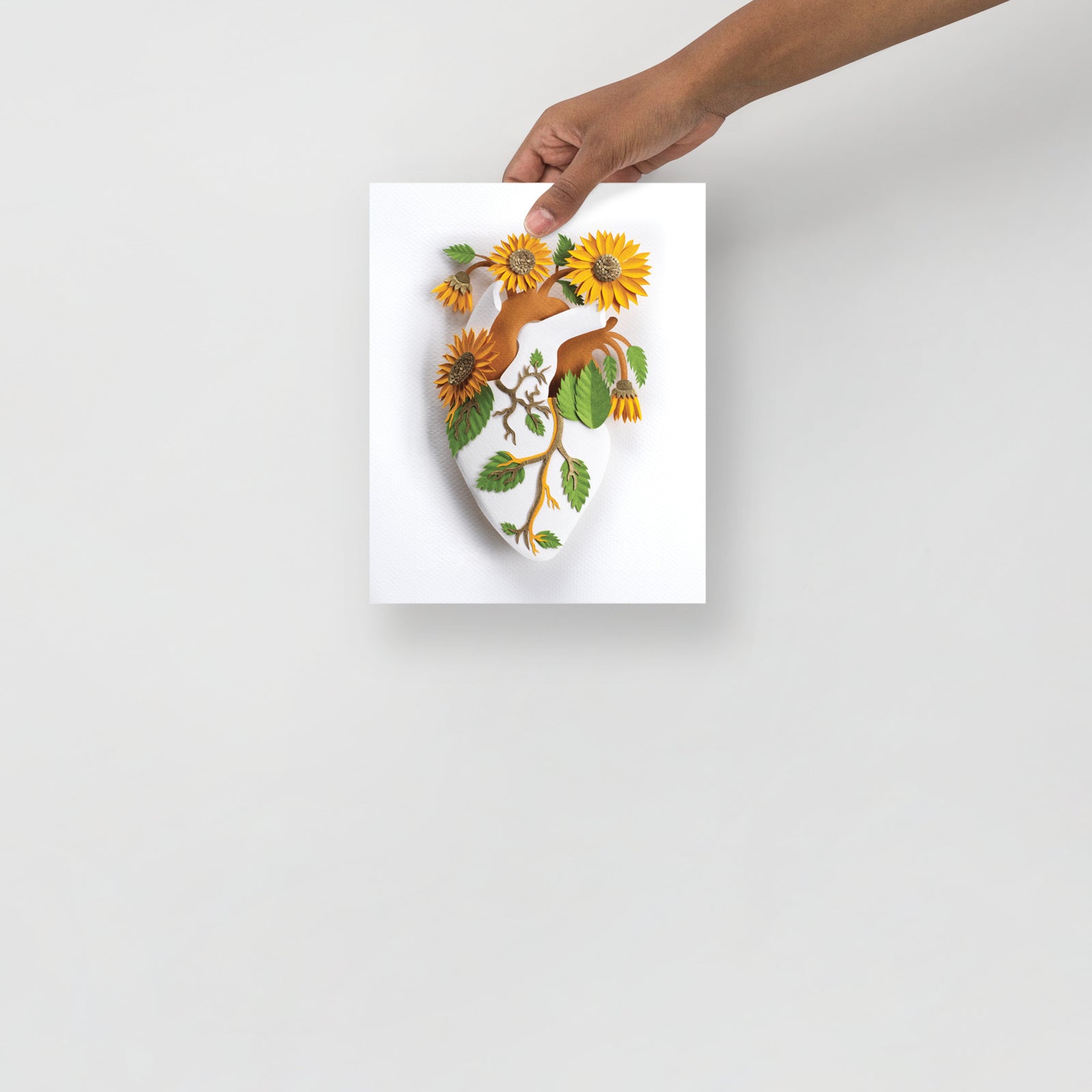 Anatomical heart and sunflowers made of cut paper